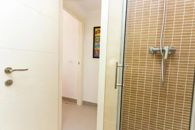 a shower with a glass door in a bathroom at Big Terrace Apartment Cullera in Cullera