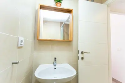 a bathroom with a sink and a mirror at Big Terrace Apartment Cullera in Cullera