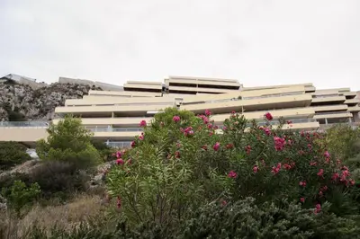 a white building with pink flowers in front of it at Big Terrace Apartment Cullera in Cullera