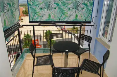 a balcony with a table and chairs on a balcony at piso con estilo cerca de la playa in Cullera