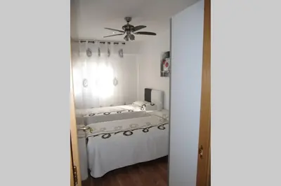 a bedroom with a bed and a ceiling fan at piso con estilo cerca de la playa in Cullera