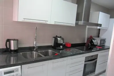 a kitchen with a sink and a microwave at piso con estilo cerca de la playa in Cullera