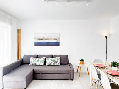a living room with a couch and a table at NUEVO, a 70 metros de la playa y con vistas al mar in Cullera