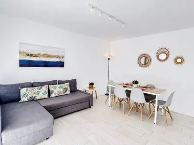 a living room with a couch and a table at NUEVO, a 70 metros de la playa y con vistas al mar in Cullera