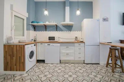 a kitchen with a refrigerator and a dishwasher at Cozy Flat in City Center Feel the Vibe SelfCheckIn in Valencia