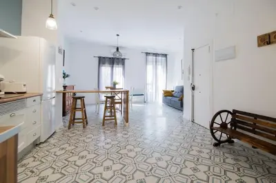 a kitchen and living room with a table and a bench at Cozy Flat in City Center Feel the Vibe SelfCheckIn in Valencia