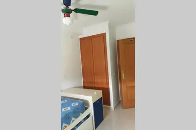 a room with a bed and a ceiling fan at APARTAMENTOFAMILIAR, PLAYA, WIFI, PISCINA in Canet de Berenguer