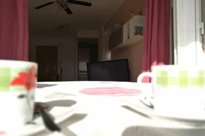 a table with a cup and a plate on it at APARTAMENTOFAMILIAR, PLAYA, WIFI, PISCINA in Canet de Berenguer