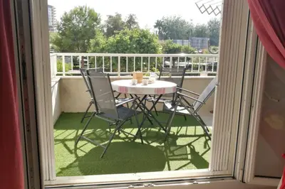 a table and chairs sitting on a balcony at APARTAMENTOFAMILIAR, PLAYA, WIFI, PISCINA in Canet de Berenguer