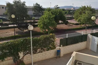 a view of a park with a fence and street lights at APARTAMENTOFAMILIAR, PLAYA, WIFI, PISCINA in Canet de Berenguer