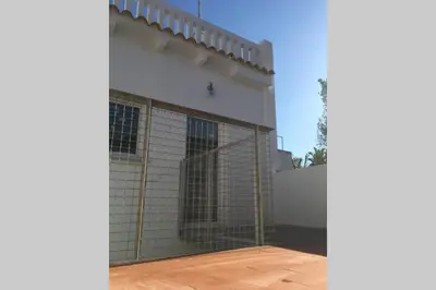 a building with a fence on the side of it at Casa La Placeta in Fortaleny