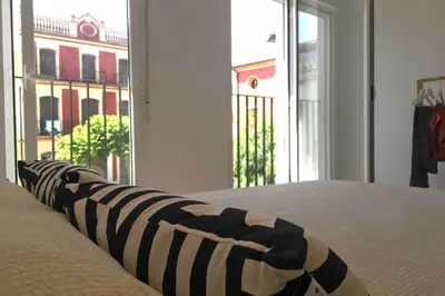 a bedroom with a bed with a view of a building at Casa La Placeta in Fortaleny