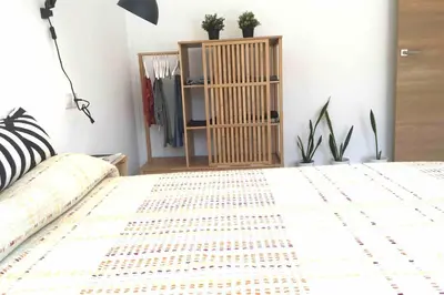 a bedroom with a bed and a shelf with plants at Casa La Placeta in Fortaleny