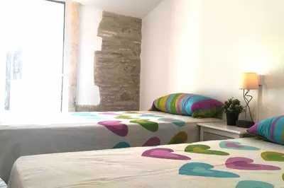 a bedroom with two beds and a window at Casa La Placeta in Fortaleny