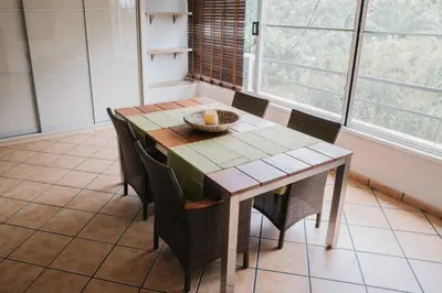 a dining room table with chairs and a basket on it at Apartamento luminoso cerca del mar y la montaña in Puzol