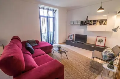 a living room with a red couch and a tv at Tranquilo y acogedor en el centro de la ciudad in Valencia