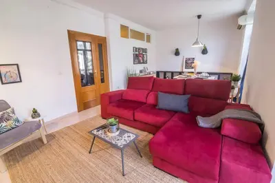 a living room with a red couch and a table at Tranquilo y acogedor en el centro de la ciudad in Valencia