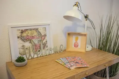 a desk with a lamp and a picture and a lampost at Tranquilo y acogedor en el centro de la ciudad in Valencia