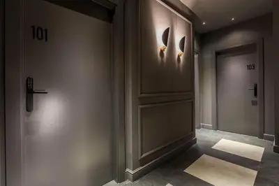 a hallway with a door with a cross on the wall at Reina 107 Beach Boutique in Valencia