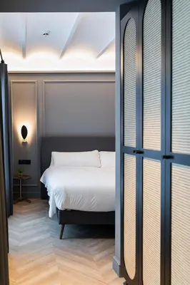 a bedroom with a white bed and a window at Reina 107 Beach Boutique in Valencia
