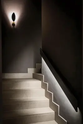 a stairway with a light on the wall and a stair case at Reina 107 Beach Boutique in Valencia