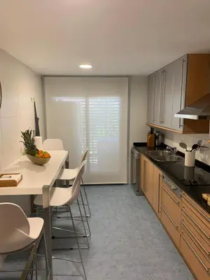 a kitchen with a counter and a table and chairs at Art and Sciences view luxury apartment in Valencia