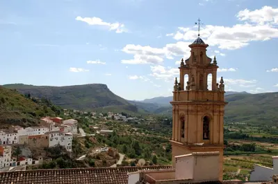 a clock tower with a view of a city at APARTAMENTOS GALLACH (LA ERMITA) in Chulilla