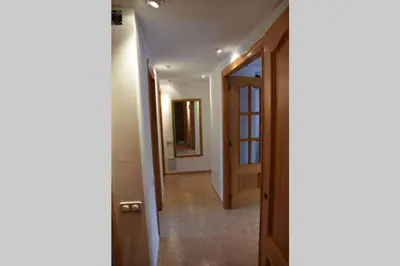 a hallway with a door leading into a room at APARTAMENTOS GALLACH (LA ERMITA) in Chulilla