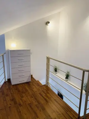 a room with a staircase and a dresser with two plants at 123rooms in Valencia