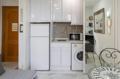 a kitchen with a refrigerator and a washing machine at Serrano Park in Valencia