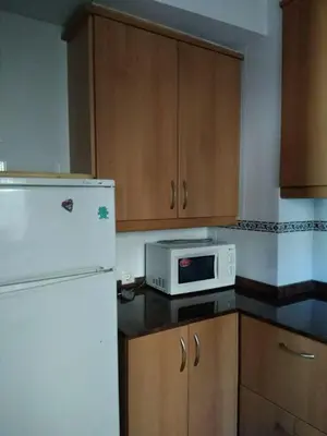 a kitchen with a white refrigerator and a microwave at Casa de Amparo y José Manuel en Pavias in Pavías
