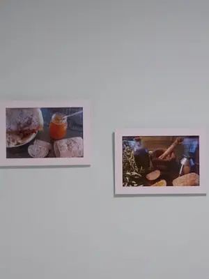 two pictures of food on a white wall at Casa de Amparo y José Manuel en Pavias in Pavías