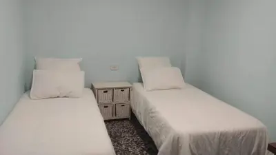 two beds sitting next to each other in a room at Casa de Amparo y José Manuel en Pavias in Pavías