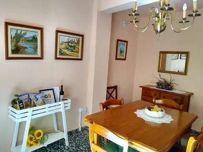 a dining room with a table and a chandelier at Casa de Amparo y José Manuel en Pavias in Pavías