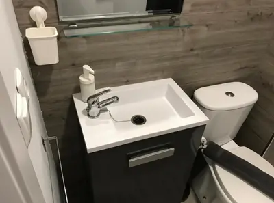 a bathroom with a sink and a toilet at Pequeño Alojamiento con Mini Piscina - NO climatizada in Valencia