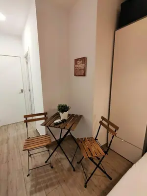 a table and two chairs in a room with a refrigerator at Pequeño Alojamiento con Mini Piscina - NO climatizada in Valencia