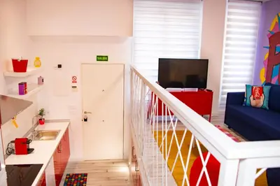 a room with a staircase with a couch and a television at Soraya's Place - Chopín 3 in Valencia
