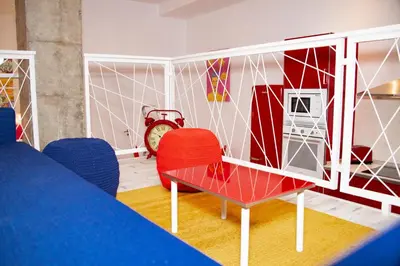 a room with a table and chairs and a clock at Soraya's Place - Chopín 3 in Valencia