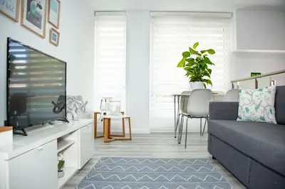 a living room with a couch and a tv at Soraya's Place - Chopín 4 in Valencia