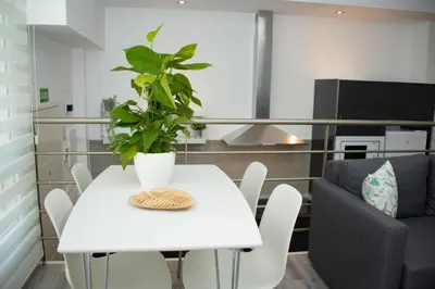 a white dining room table with a plant on it at Soraya's Place - Chopín 4 in Valencia