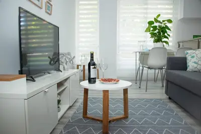 a living room with a bottle of wine on a table at Soraya's Place - Chopín 4 in Valencia