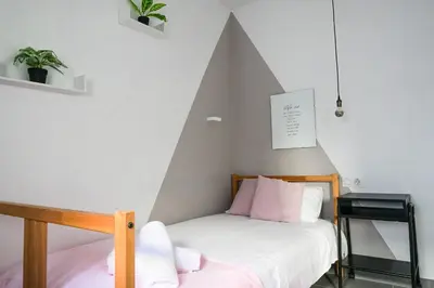 a bedroom with a bed with a triangular wall at Torres de Serrano Apartment in Valencia