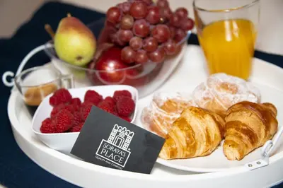 a tray of pastries and fruit on a table at Soraya's Place - Chopín 5 in Valencia