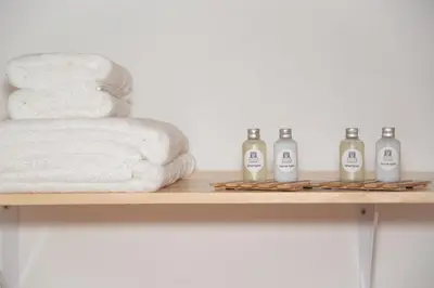 a shelf with towels and bottles on it at Soraya's Place - Chopín 5 in Valencia
