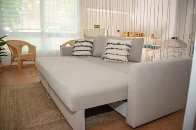 a couch with pillows on it in a living room at Soraya's Place - Chopín 5 in Valencia