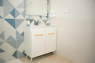 a bathroom with a white cabinet and a mirror at Soraya's Place - Chopín 5 in Valencia