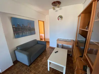 a living room with a couch and a table at Piso cerca de la playa - Act. Mauri 1B in Valencia