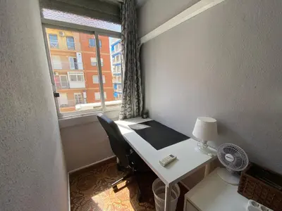 a room with a desk with a window and a deskablish at Piso cerca de la playa - Act. Mauri 1B in Valencia