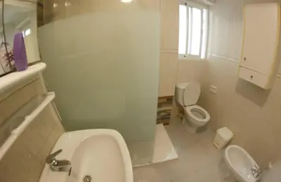 a bathroom with a white toilet and a sink at apartemento ideal familia y grupo climatisacion playa poblaA in Valencia