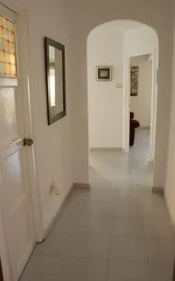a hallway with white walls and a white tile floor at apartemento ideal familia y grupo climatisacion playa poblaA in Valencia